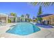 Stunning backyard oasis with a pool, ample seating, and mature trees providing shade at 2046 E Downing St, Mesa, AZ 85213