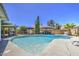 Spacious backyard showcasing a large pool, outdoor dining area, and well-maintained landscaping at 2046 E Downing St, Mesa, AZ 85213