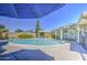 Sparkling pool surrounded by a concrete patio and a covered seating area for outdoor relaxation at 2046 E Downing St, Mesa, AZ 85213