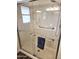 Modern walk-in shower featuring sleek glass doors and grab bars for accessibility at 2046 E Downing St, Mesa, AZ 85213