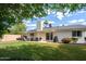 Lush backyard with covered patio, seating area, and mature landscaping for outdoor gatherings at 2418 E Hermosa Dr, Tempe, AZ 85282