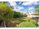 Expansive backyard with thriving garden, mature landscaping, and secured block fence for peace and enjoyment at 2418 E Hermosa Dr, Tempe, AZ 85282