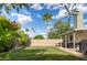 Green backyard featuring a covered patio, barbecue grill, and mature landscaping, perfect for entertaining at 2418 E Hermosa Dr, Tempe, AZ 85282