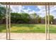 View from outdoor patio to backyard, highlighting the well-kept lawn, mature trees, and private fenced yard at 2418 E Hermosa Dr, Tempe, AZ 85282