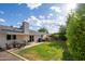 Expansive backyard featuring a covered patio, lush lawn, and mature landscaping perfect for outdoor living at 2418 E Hermosa Dr, Tempe, AZ 85282