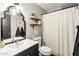 Bathroom features a vessel sink and vanity, decorative mirror, and a shower with curtain at 2418 E Hermosa Dr, Tempe, AZ 85282