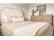 A well staged bedroom with a large upholstered headboard and a dresser with mirror at 2418 E Hermosa Dr, Tempe, AZ 85282