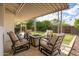 Cozy covered patio with fire pit and comfortable seating, ideal for outdoor entertainment and relaxation at 2418 E Hermosa Dr, Tempe, AZ 85282