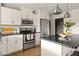 Bright kitchen with white cabinets, black countertops, and stainless steel appliances, perfect for cooking and entertaining at 2418 E Hermosa Dr, Tempe, AZ 85282