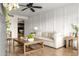 Bright living room with a modern accent wall, neutral furniture, and open access to the dining area at 2418 E Hermosa Dr, Tempe, AZ 85282