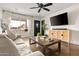 Charming living room boasting a comfortable sofa, media console, and natural lighting, perfect for relaxation at 2418 E Hermosa Dr, Tempe, AZ 85282