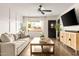 Bright living room featuring a neutral sofa, modern decor, and natural light from the window at 2418 E Hermosa Dr, Tempe, AZ 85282