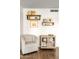 Bright living room with floating shelves, a chair, and built-in storage at 2418 E Hermosa Dr, Tempe, AZ 85282