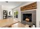 Interior shot with a fireplace, wooden accent wall, and sliding glass doors leading to an outdoor space at 2418 E Hermosa Dr, Tempe, AZ 85282