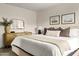 Well-lit main bedroom featuring neutral tones, a mirror, and bedside table at 2418 E Hermosa Dr, Tempe, AZ 85282