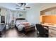 Bedroom featuring hardwood floors, a ceiling fan, a desk, and a window at 24229 W Tonto St, Buckeye, AZ 85326
