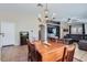 Dining area featuring tile flooring, a chandelier, and adjacent living area at 24229 W Tonto St, Buckeye, AZ 85326