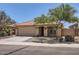 Charming single-story home featuring a two-car garage, front yard landscaping, and desert rock at 24229 W Tonto St, Buckeye, AZ 85326