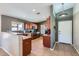 Well-lit kitchen featuring wood cabinets, tile flooring, and updated appliances at 24229 W Tonto St, Buckeye, AZ 85326