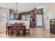 Open kitchen and dining area with tile flooring and an elegant chandelier at 24229 W Tonto St, Buckeye, AZ 85326