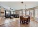 Bright open-concept living room and dining area with a cozy sectional sofa at 24229 W Tonto St, Buckeye, AZ 85326