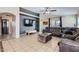 Comfortable living room with tile flooring, a sectional sofa, and a large TV at 24229 W Tonto St, Buckeye, AZ 85326