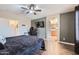 Main bedroom featuring hardwood floors, ceiling fan, and ensuite bathroom at 24229 W Tonto St, Buckeye, AZ 85326
