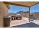 Covered patio featuring a brick outdoor kitchen, built-in grill, countertop space and seating, perfect for entertaining at 24229 W Tonto St, Buckeye, AZ 85326