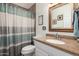 Bathroom featuring a vanity with gold fixtures and framed mirror at 24648 N 40Th Ln, Glendale, AZ 85310
