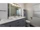 Bright bathroom featuring a double sink vanity with marble countertop and modern fixtures at 24648 N 40Th Ln, Glendale, AZ 85310