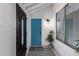Welcoming entryway featuring a stylish front door, black and white tiled floors, and modern lighting at 24648 N 40Th Ln, Glendale, AZ 85310