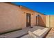 Exterior of home showing the front door with a security light, small stoop, and a neat yard at 24648 N 40Th Ln, Glendale, AZ 85310