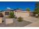 Charming single-story home with a two-car garage, desert landscaping, and clear blue skies at 24648 N 40Th Ln, Glendale, AZ 85310