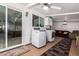 Well-lit laundry room with white cabinets, tile floors, and a washer and dryer at 24648 N 40Th Ln, Glendale, AZ 85310