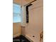 Modern shower with a sleek, black multi-function shower panel and patterned curtain at 24648 N 40Th Ln, Glendale, AZ 85310