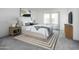 Bright bedroom features a bed, stylish rug, and ample natural light from the window at 29789 N Oak Dr, Florence, AZ 85132