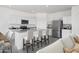 Modern kitchen with white cabinets, granite countertops, stainless steel appliances, and seating at the island at 29789 N Oak Dr, Florence, AZ 85132