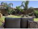 Serene backyard with desert landscaping, a green lawn, and cozy seating, creating a peaceful retreat at 30178 N Coral Bean Dr, San Tan Valley, AZ 85143