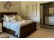 Charming bedroom with wood bed frame, neutral walls and a painting of trees at 30178 N Coral Bean Dr, San Tan Valley, AZ 85143