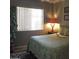 Bedroom with window, a lamp, decorative zebra rug and palm tree like plant at 30178 N Coral Bean Dr, San Tan Valley, AZ 85143