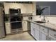 Bright kitchen features stainless steel appliances, white cabinets, granite countertops, and tiled backsplash at 30178 N Coral Bean Dr, San Tan Valley, AZ 85143
