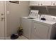 Laundry room with a white washer and dryer with white cabinets at 30178 N Coral Bean Dr, San Tan Valley, AZ 85143