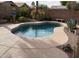 Inviting backyard pool surrounded by desert landscaping and a large deck, perfect for outdoor entertainment at 30178 N Coral Bean Dr, San Tan Valley, AZ 85143