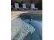 Close-up view of a sparkling pool with steps and lounge chairs, offering a refreshing outdoor experience at 30178 N Coral Bean Dr, San Tan Valley, AZ 85143