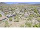 Picturesque aerial view of a residential area with pools and desert vegetation at 30374 N 124Th Dr, Peoria, AZ 85383