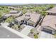 Stunning aerial view of a modern home with tile roof, desert landscaping, and a spacious driveway at 30374 N 124Th Dr, Peoria, AZ 85383