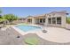 Stunning backyard featuring a sparkling pool, putting green, and well-manicured landscaping at 30374 N 124Th Dr, Peoria, AZ 85383