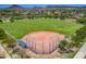 Aerial view of the community baseball field, complete with fenced backstop and scenic mountain views at 30374 N 124Th Dr, Peoria, AZ 85383