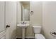 Cozy powder room with a pedestal sink, toilet, and a large mirror at 30374 N 124Th Dr, Peoria, AZ 85383