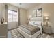 Comfortable bedroom features a plush bed, neutral decor, and a bright window with curtains at 30374 N 124Th Dr, Peoria, AZ 85383